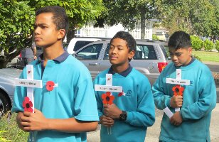 Three boys bringing crosses to the Field